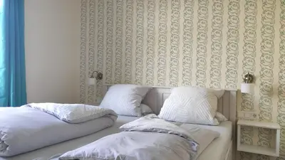 Ein Bett oder Betten in einem Zimmer der Unterkunft Herrenhaus Schmölen GbR