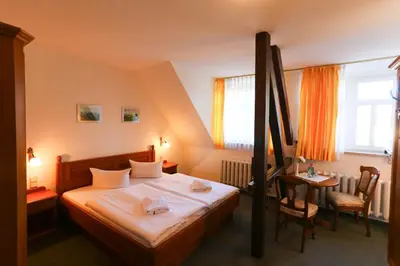 Ein Bett oder Betten in einem Zimmer der Unterkunft Parkhotel Forsthaus