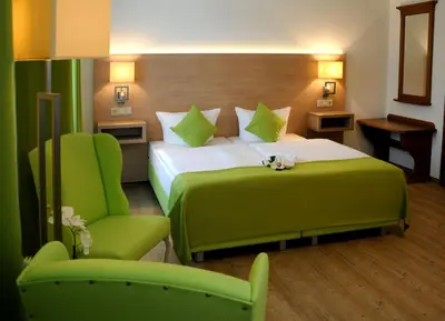 Ein Bett oder Betten in einem Zimmer der Unterkunft Parkhotel Forsthaus