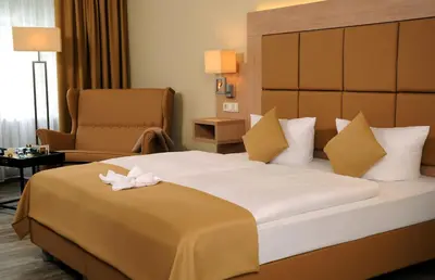 Ein Bett oder Betten in einem Zimmer der Unterkunft Parkhotel Forsthaus
