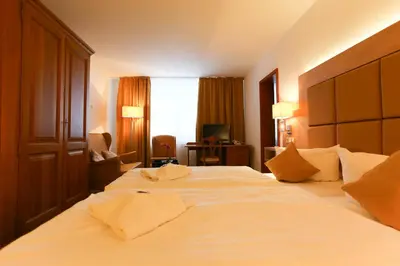 Ein Bett oder Betten in einem Zimmer der Unterkunft Parkhotel Forsthaus