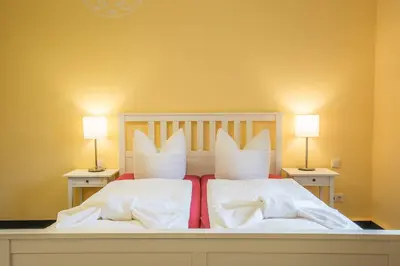Ein Bett oder Betten in einem Zimmer der Unterkunft Parkhotel Muldental