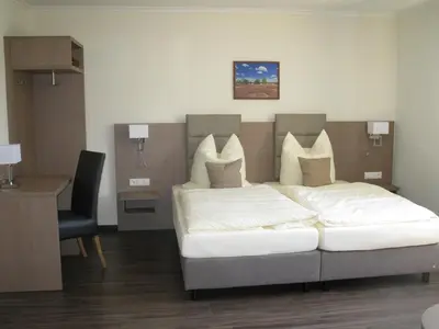 Ein Bett oder Betten in einem Zimmer der Unterkunft Heidepension Anja