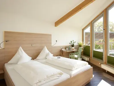 Ein Bett oder Betten in einem Zimmer der Unterkunft Hotel Forsthaus Grüna Betreibergesellschaft mbH