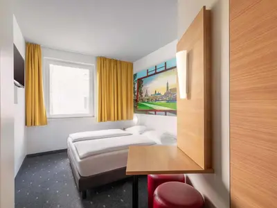 Ein Bett oder Betten in einem Zimmer der Unterkunft B&B Hotel Dresden-Messe