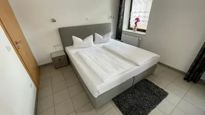 Ein Bett oder Betten in einem Zimmer der Unterkunft Avenue Das Gästehaus