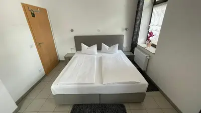 Ein Bett oder Betten in einem Zimmer der Unterkunft Avenue Das Gästehaus