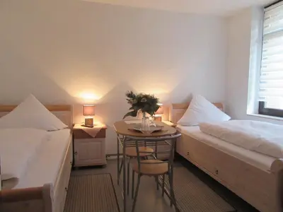 Ein Bett oder Betten in einem Zimmer der Unterkunft Avenue Das Gästehaus
