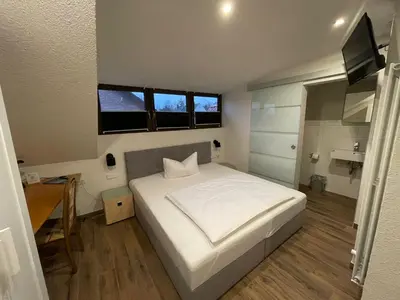 Ein Bett oder Betten in einem Zimmer der Unterkunft Avenue Das Gästehaus