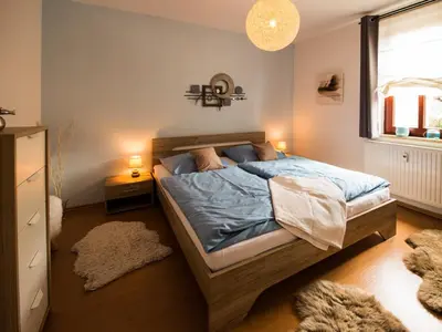 Ein Bett oder Betten in einem Zimmer der Unterkunft Ferienwohnung am Weissen Hirsch