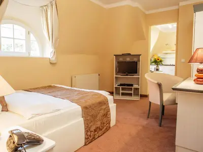 Ein Bett oder Betten in einem Zimmer der Unterkunft Aparthotel Villa Freisleben