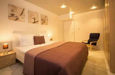 Ein Bett oder Betten in einem Zimmer der Unterkunft Aparthotel Villa Freisleben
