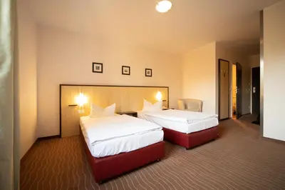 Ein Bett oder Betten in einem Zimmer der Unterkunft Bergwirtschaft Wilder Mann Hotel und Restaurant
