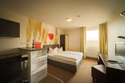 Ein Bett oder Betten in einem Zimmer der Unterkunft Bergwirtschaft Wilder Mann Hotel und Restaurant