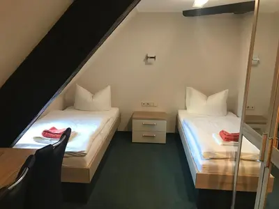 Ein Bett oder Betten in einem Zimmer der Unterkunft Schlossgasthaus Lichtenwalde