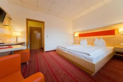 Ein Bett oder Betten in einem Zimmer der Unterkunft City Hotel