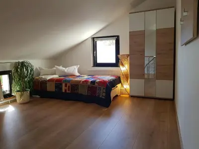 Ein Bett oder Betten in einem Zimmer der Unterkunft Ferienhaus Balkenkunst