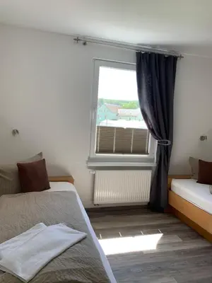 Ein Bett oder Betten in einem Zimmer der Unterkunft Hotel Bannewitz B&B