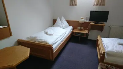 Ein Bett oder Betten in einem Zimmer der Unterkunft Pension Erbgericht