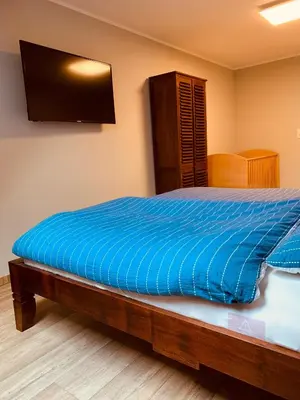 Ein Bett oder Betten in einem Zimmer der Unterkunft Ferienwohnungen Siebenlehn am Romanus Freibad