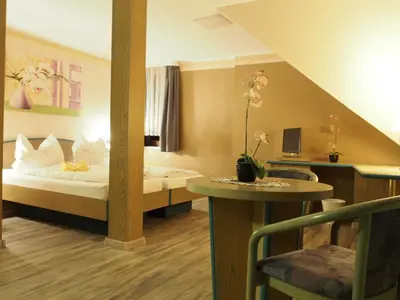 Ein Bett oder Betten in einem Zimmer der Unterkunft Pension Ottendorf-Okrilla