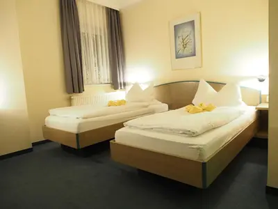 Ein Bett oder Betten in einem Zimmer der Unterkunft Pension Ottendorf-Okrilla