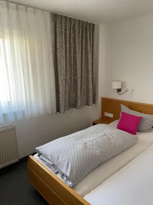 Ein Bett oder Betten in einem Zimmer der Unterkunft Pension Arcade