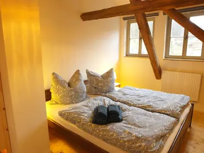 Ein Bett oder Betten in einem Zimmer der Unterkunft “Mägdestube” - Hammergut Neidberg