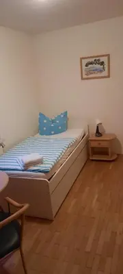 Ein Bett oder Betten in einem Zimmer der Unterkunft Pension Sorrento