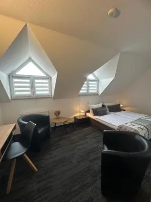 Ein Bett oder Betten in einem Zimmer der Unterkunft Hotel Bergschlößchen