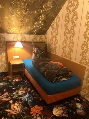 Ein Bett oder Betten in einem Zimmer der Unterkunft Hotel Eulenspiegel - Das Erlebnishotel in Riesa