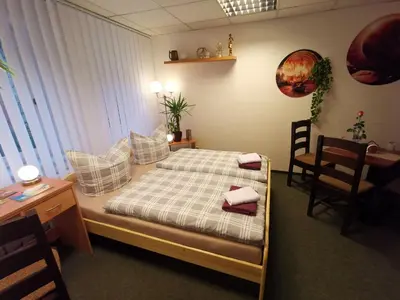 Ein Bett oder Betten in einem Zimmer der Unterkunft Gästezimmer Am Gewölbekeller