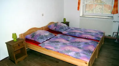 Ein Bett oder Betten in einem Zimmer der Unterkunft Gästewohnung am Thümmlitzwald
