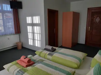 Ein Bett oder Betten in einem Zimmer der Unterkunft Pension Schöne