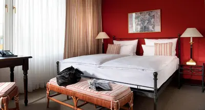 Ein Bett oder Betten in einem Zimmer der Unterkunft Hotel Elbflorenz Dresden