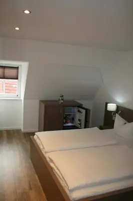 Ein Bett oder Betten in einem Zimmer der Unterkunft Hotel Am Obermarkt