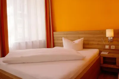 Ein Bett oder Betten in einem Zimmer der Unterkunft Hotel Am Obermarkt