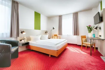 Ein Bett oder Betten in einem Zimmer der Unterkunft ACHAT Hotel Chemnitz