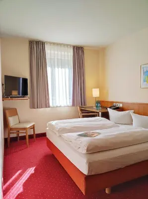 Ein Bett oder Betten in einem Zimmer der Unterkunft ACHAT Hotel Chemnitz