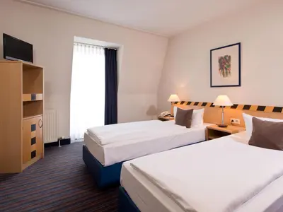 Ein Bett oder Betten in einem Zimmer der Unterkunft ACHAT Hotel Dresden Elbufer