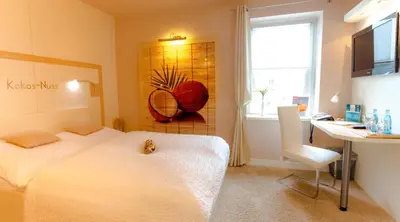 Ein Bett oder Betten in einem Zimmer der Unterkunft Hotel Röhrsdorfer Hof