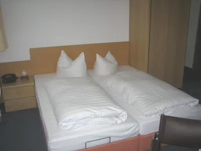 Ein Bett oder Betten in einem Zimmer der Unterkunft Hotel Heidenschanze
