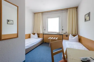 Ein Bett oder Betten in einem Zimmer der Unterkunft Hotel Heidenschanze