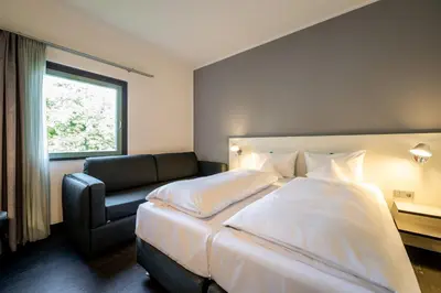 Ein Bett oder Betten in einem Zimmer der Unterkunft Dresdner Tor Süd