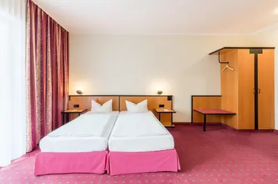 Ein Bett oder Betten in einem Zimmer der Unterkunft Andante Hotel Dresden