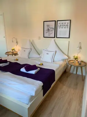 Ein Bett oder Betten in einem Zimmer der Unterkunft Gästehaus am Markt - Leisnig