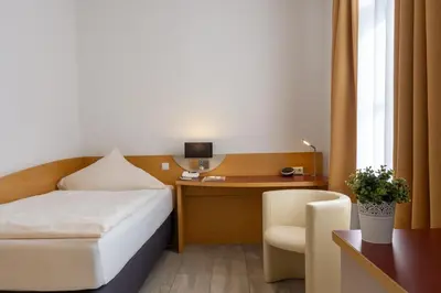 Ein Bett oder Betten in einem Zimmer der Unterkunft Hotel Alte Mühle