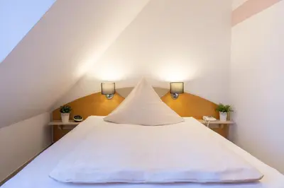Ein Bett oder Betten in einem Zimmer der Unterkunft Hotel Alte Mühle