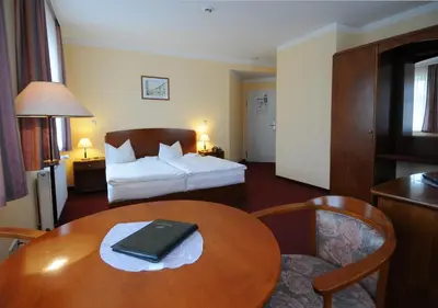 Ein Bett oder Betten in einem Zimmer der Unterkunft Hotel Döbelner Hof