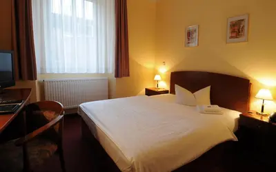 Ein Bett oder Betten in einem Zimmer der Unterkunft Hotel Döbelner Hof